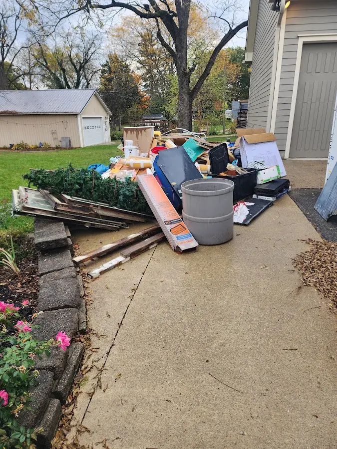 Dumpster being loaded with debris for Commercial Dumpster Rental in Alma